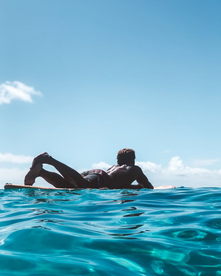 Low Angle View Of Man Floating On Water