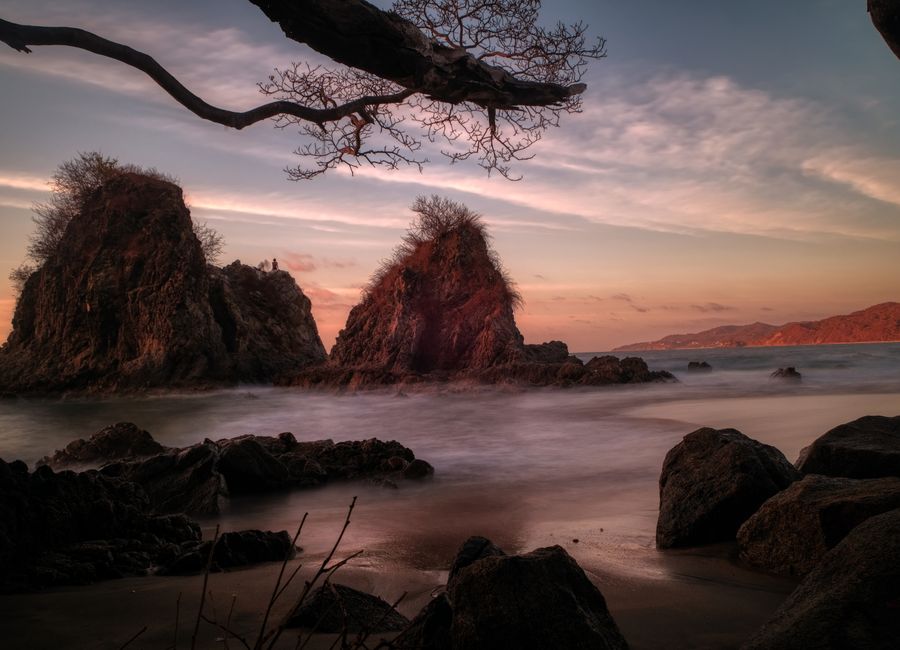 Captivating seascape of Sayulita's rock formations during a vibrant dusk.