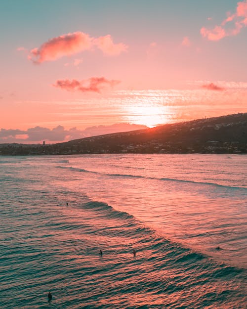 Body of Water Near Mountain during Sunset