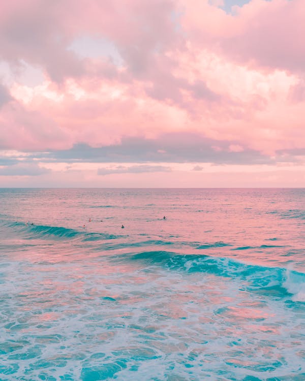 Blue Ocean Water Under White Clouds on Pink Sky · Free Stock Photo