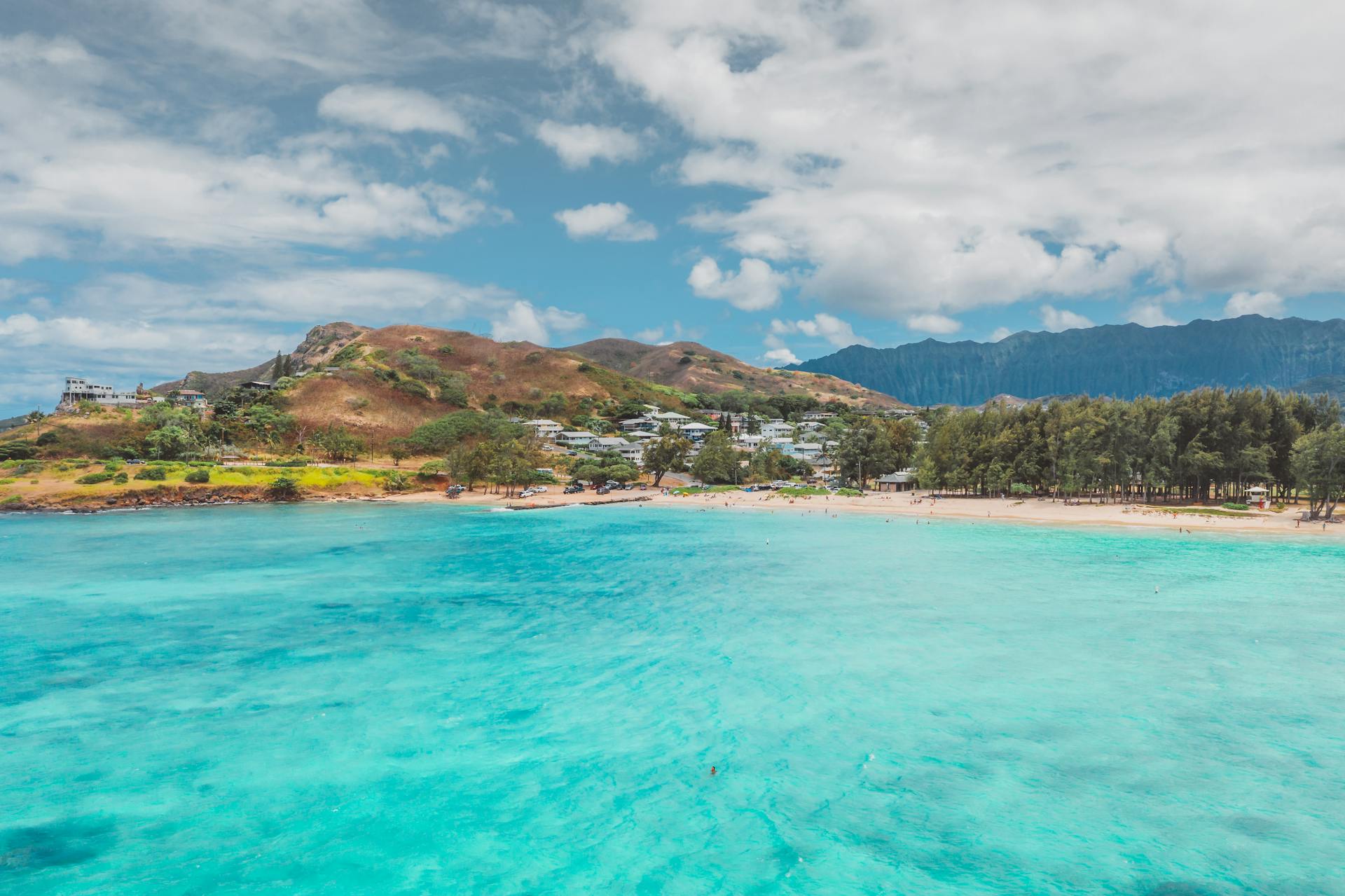 Vibrant tropical landscape showcasing turquoise waters and a lush island under a bright blue sky.