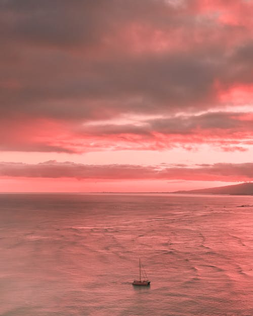 Body of Water Under Pink Cloudy Sky