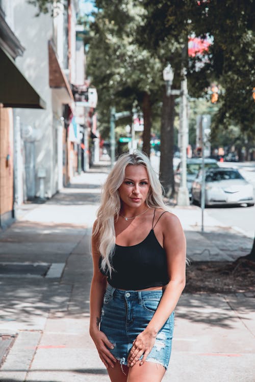 Woman in Black Top and Denim Skirt