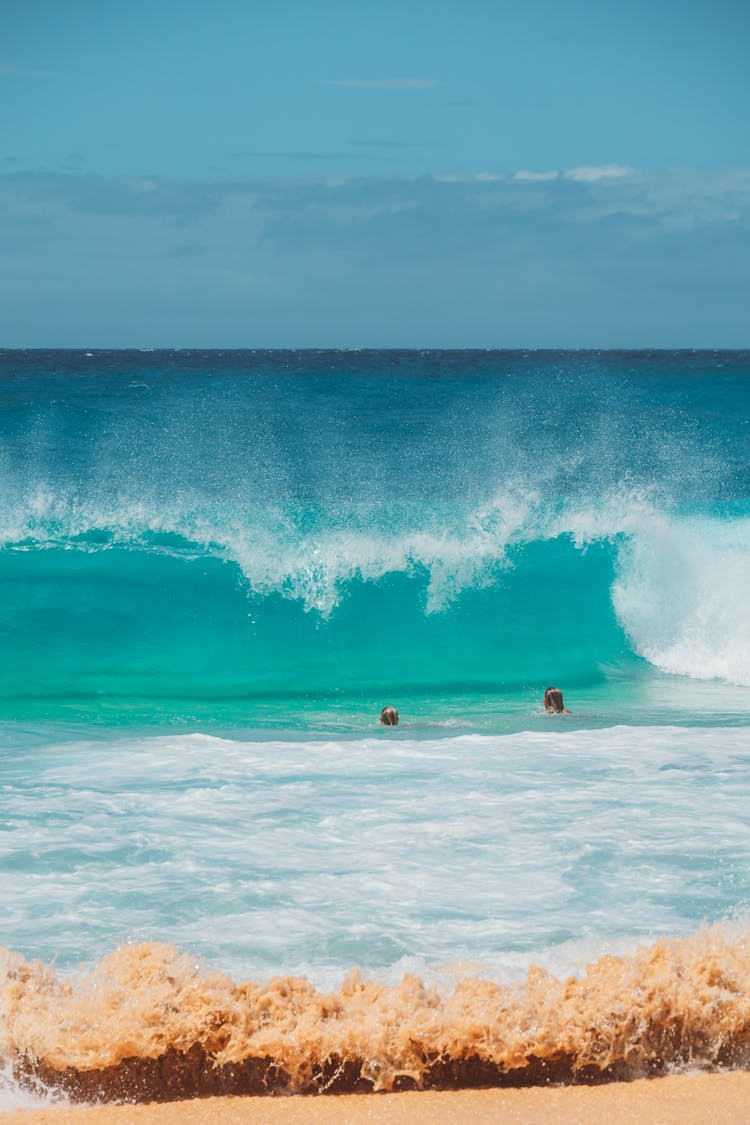 People Enjoying The Big Waves Of The Sea