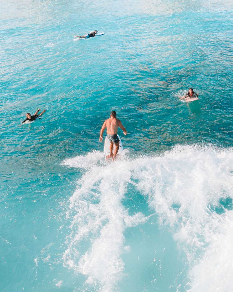 Surfers Enjoying The Big Waves Of The Sea