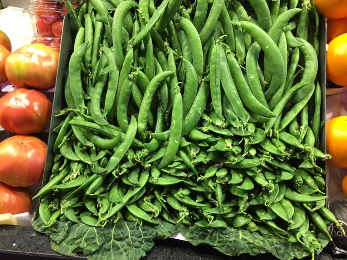 Fresh green peas in open pods