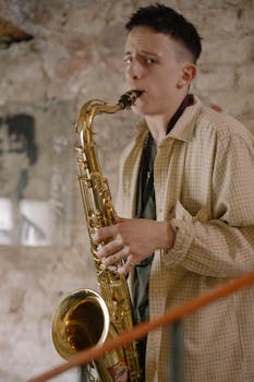 Young saxophonist playing a saxophone indoors, showcasing musical talent.