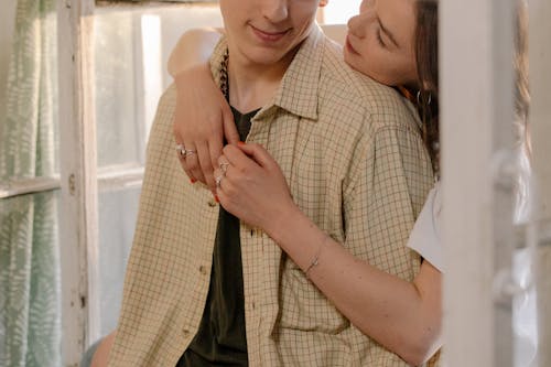 Woman in White Dress Shirt and Brown Plaid Button Up Shirt