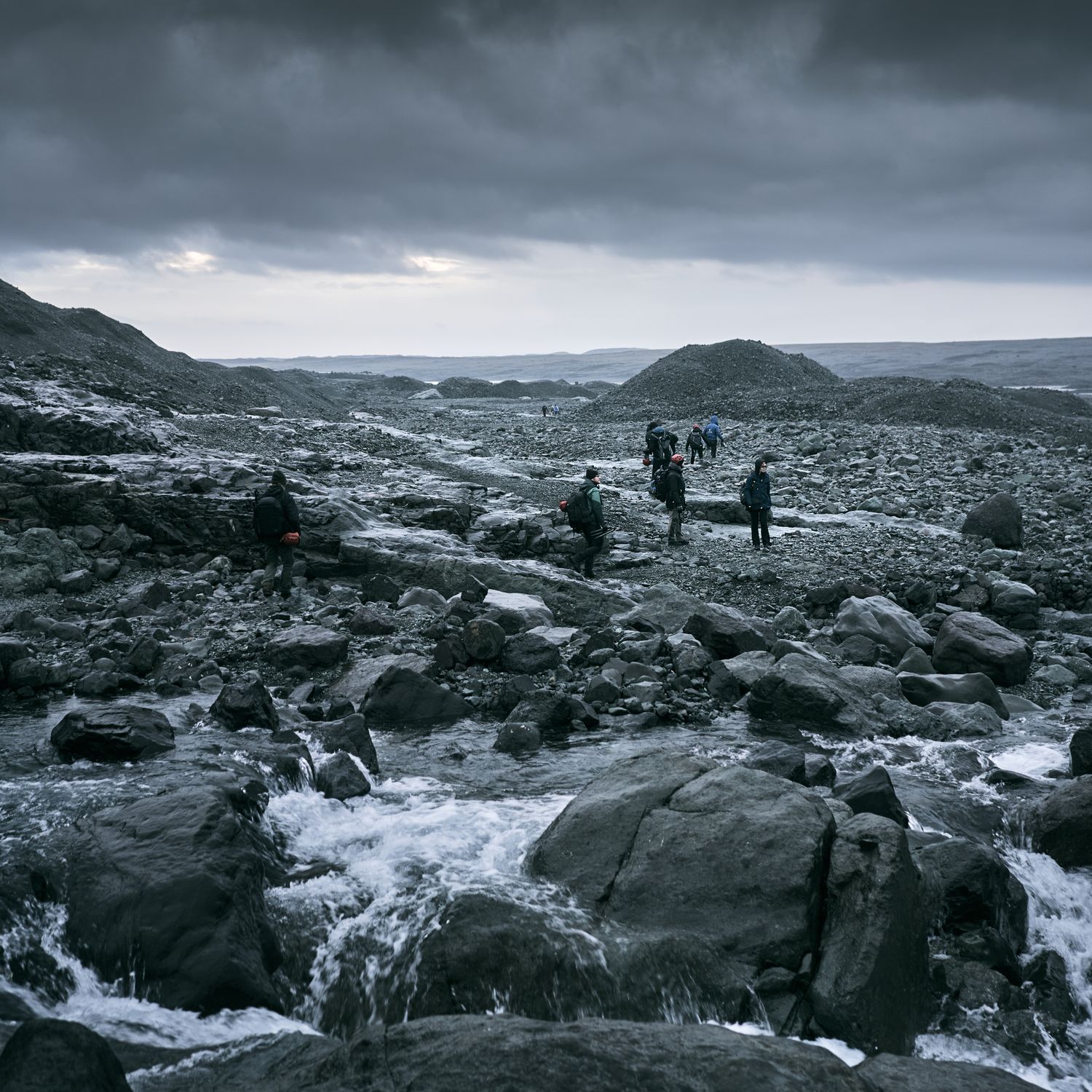 Group of expedition hikers crossing a rugged rocky landscape in the backcountry Group of expedition hikers crossing a rugged rocky landscape in the backcountry
