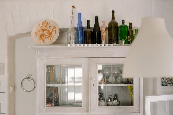 Decorative glass bottles displayed on a cabinet