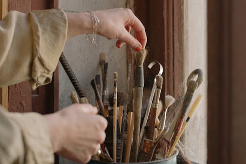 Person Holding Brown Wooden Handle Paint Brush