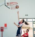 Woman throwing basketball ball in hoop
