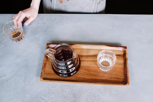 Clear Glass Cup on Brown Wooden Tray
