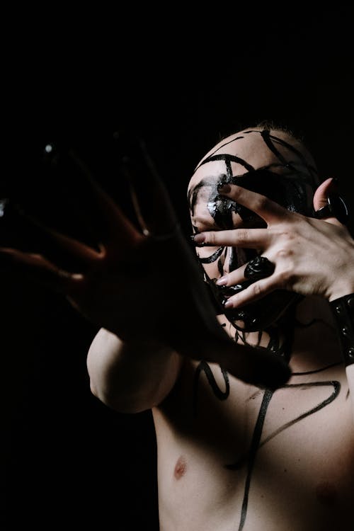 Woman in Black Brassiere Covering Face With Hands