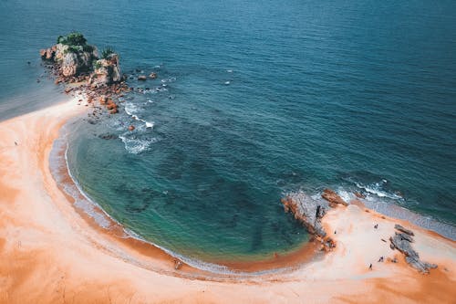 Magnificent aerial view of tropical sandy beach with emerald water of calm rippled sea