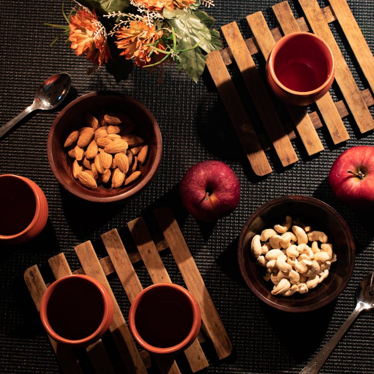 
A Flatlay Of A Tablescape With Nuts And Apples