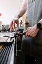 Man in Gray Shirt Holding Silver and Black Coffee Maker