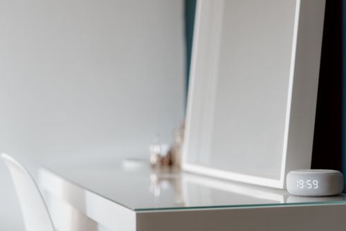 Free Elegant minimalist white desk setup with a digital clock in a serene setting. Stock Photo