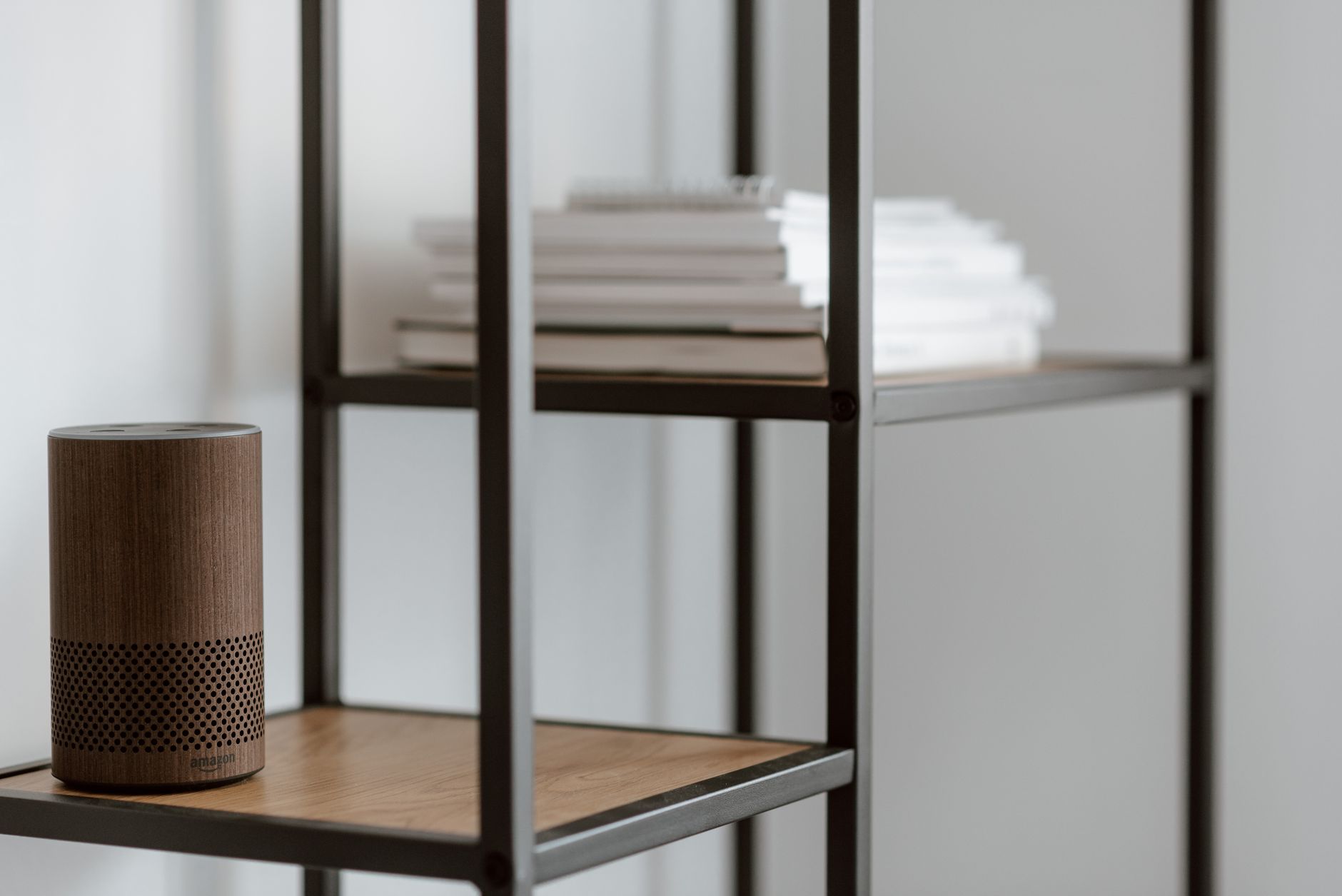 A smart speaker on a bedside table