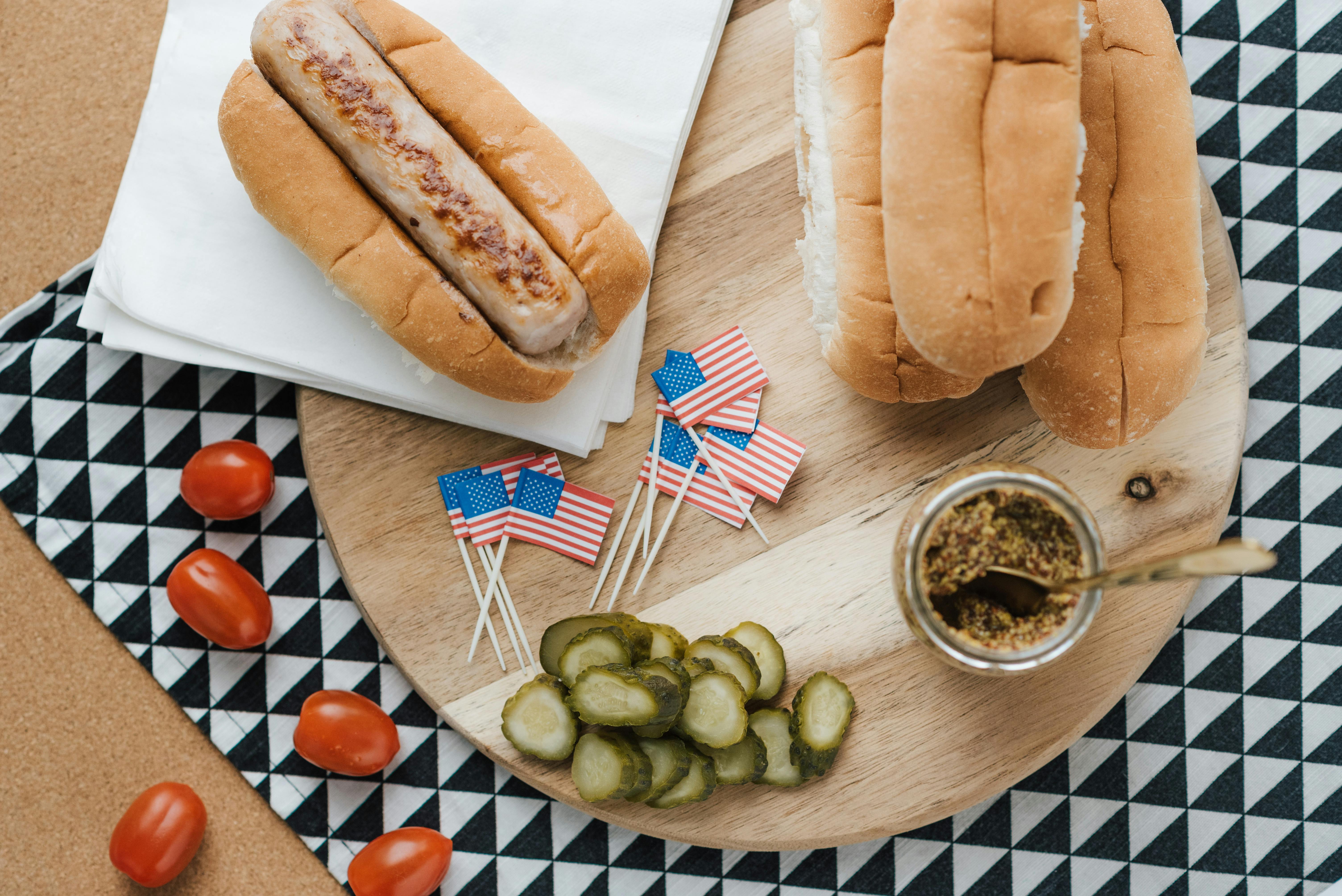 Top view of hot dogs with American flags, perfect for 4th of July celebrations.