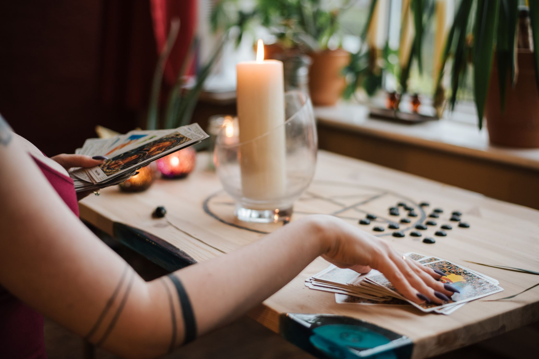 Anonymous soothsayer reading tarot cards during divination process in ...