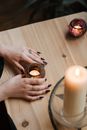 Crop fortune teller with shiny candles at table