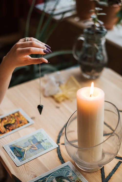 Corte O Adivinho Com Cartas De Talismã E Tarô Perto De Uma Vela Acesa