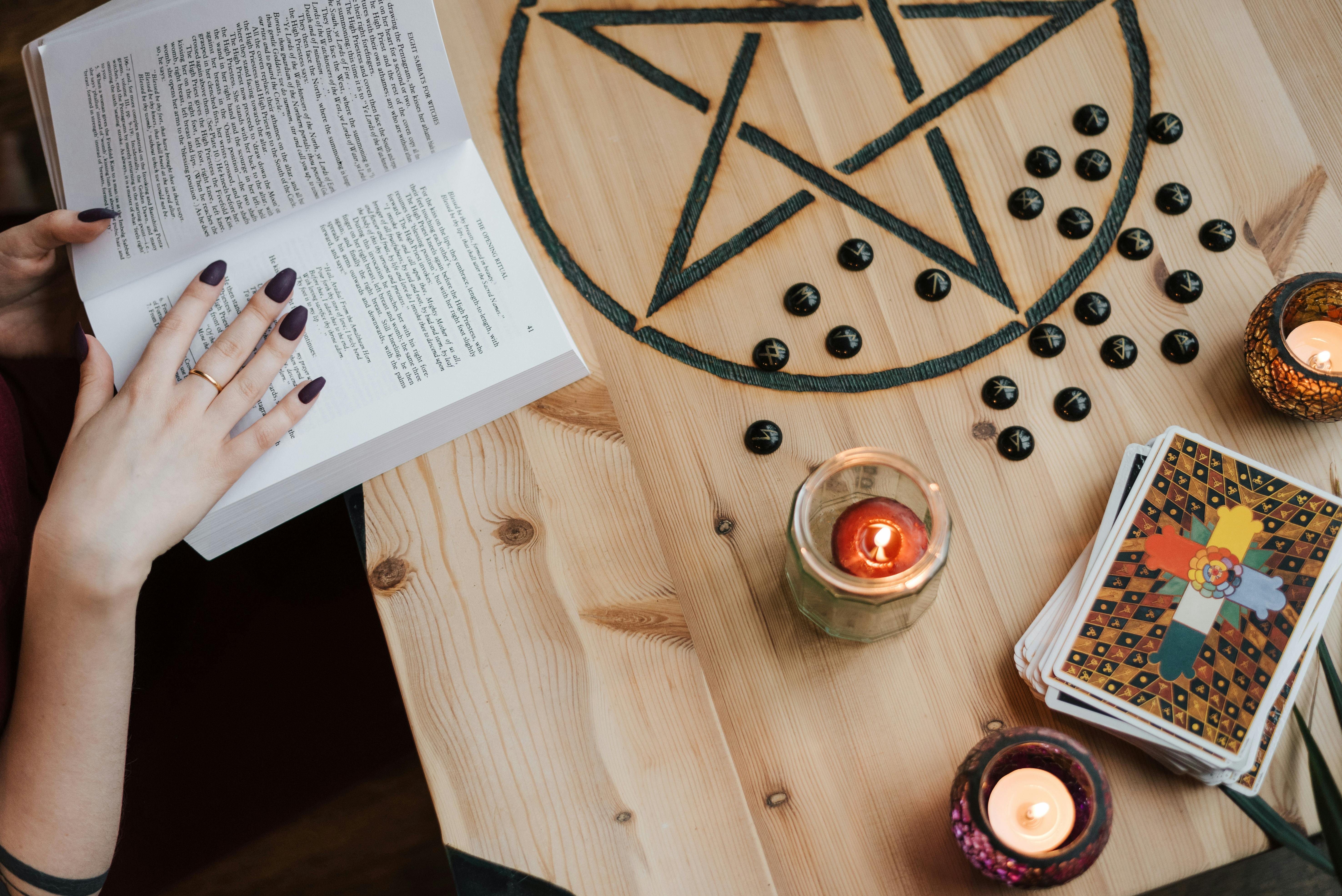 faceless soothsayer reading magic book while predicting fate