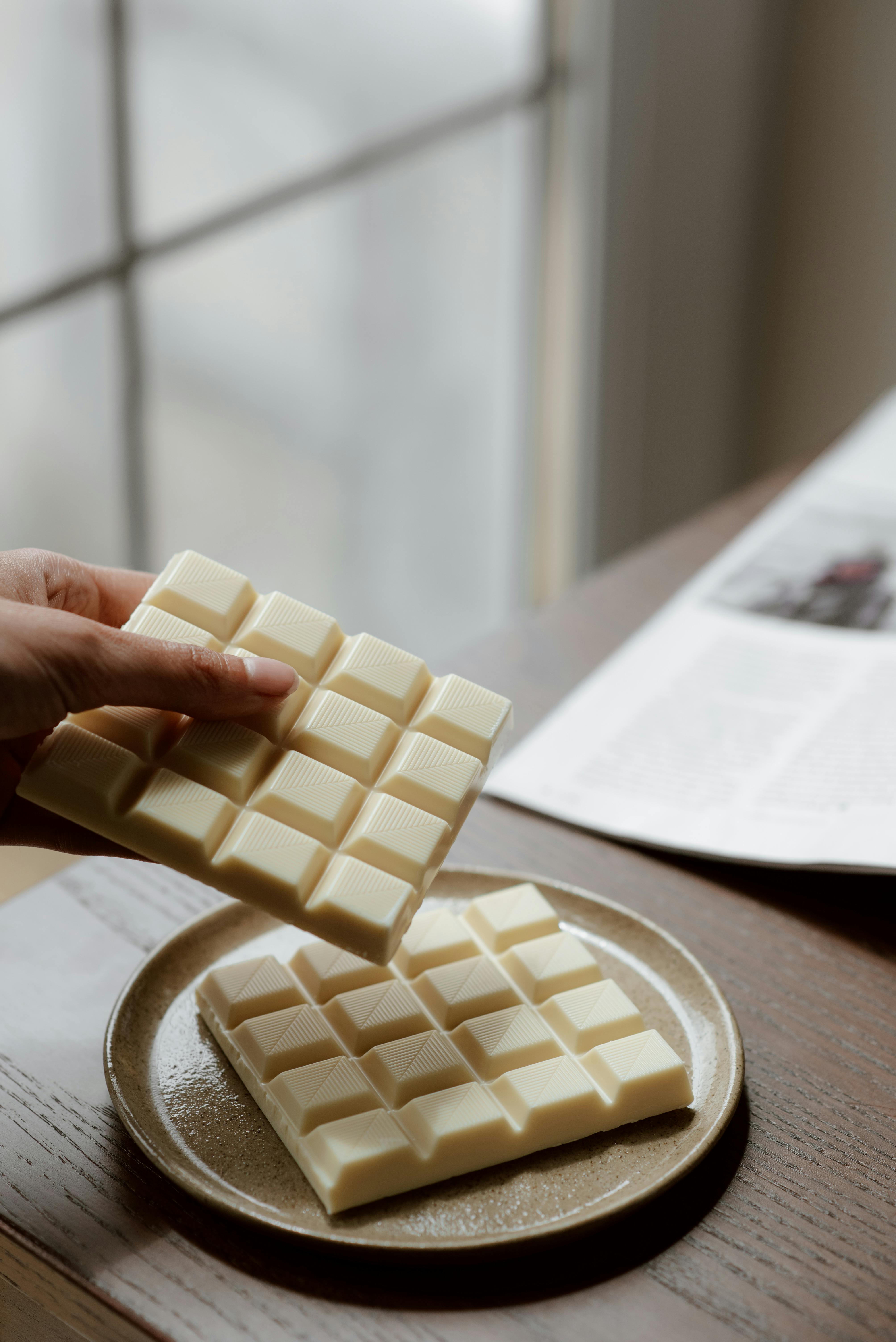 crop person holding bar of chocolate