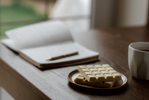 Delicious chocolate near coffee and notebook