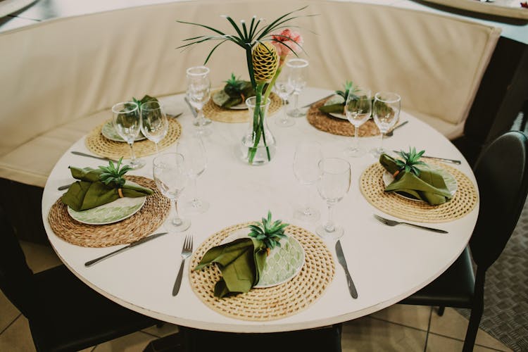 Banquet Round Table With Green Napkins And Decorations