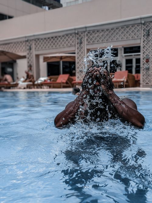 Free stock photo of indoor swimming pool, people swimming underwater, pool area Stock Photo