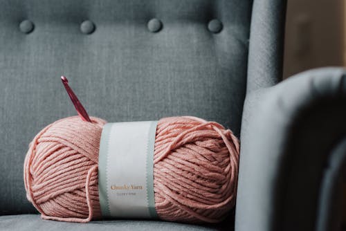 Розовая пряжа для вязания на диване