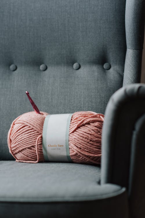 Free Armchair with pink yarn for knitting Stock Photo