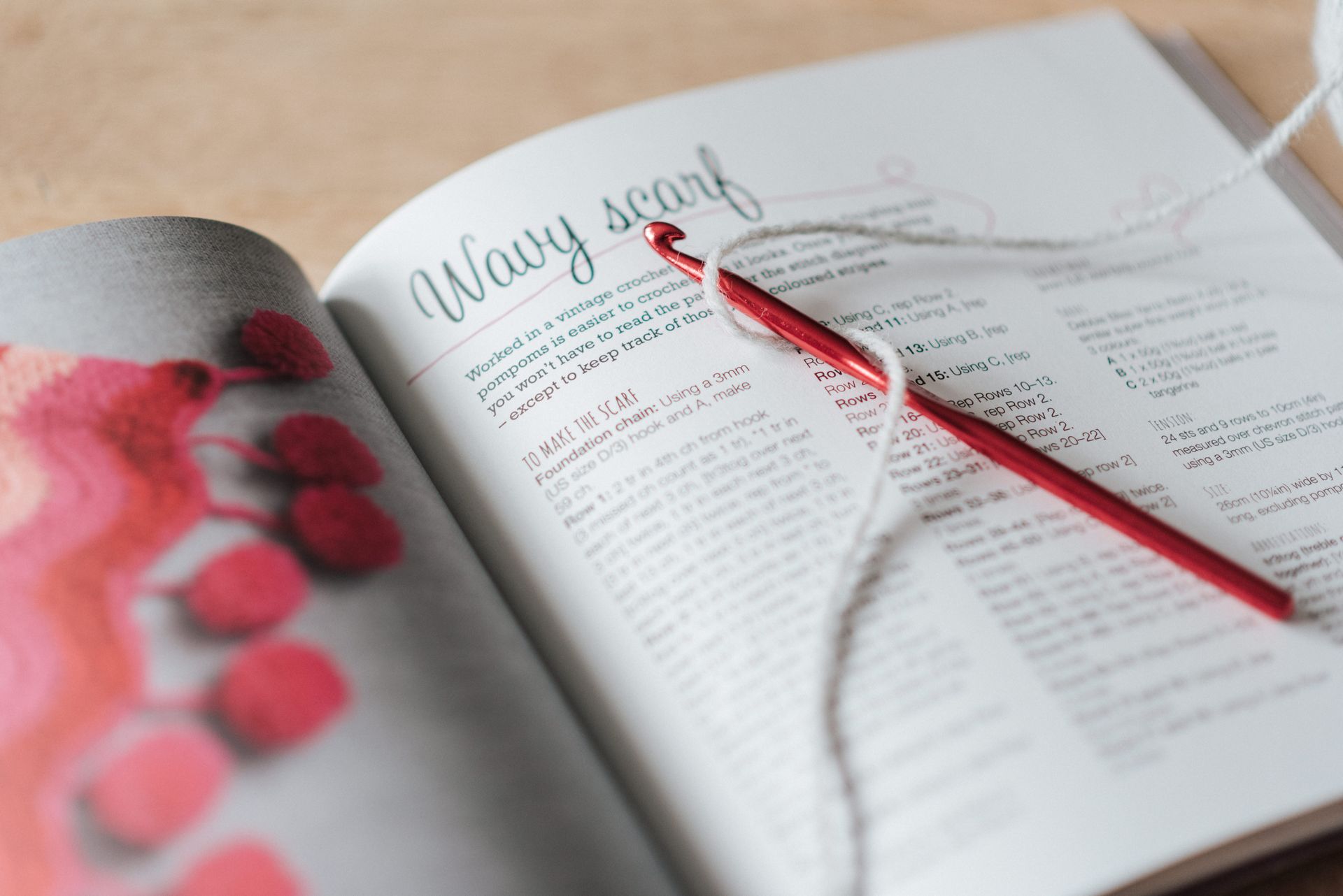 Crochet and thread on magazine in daytime