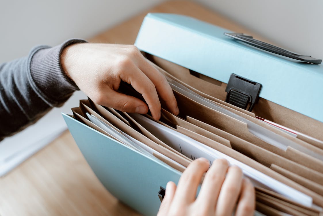 Free Person choosing document in folder Stock Photo