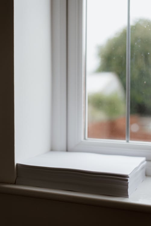 Stack Of White Paper Placed On Windowsill