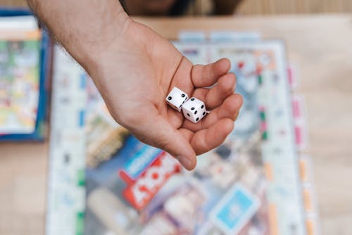 Crop player with dices playing board game