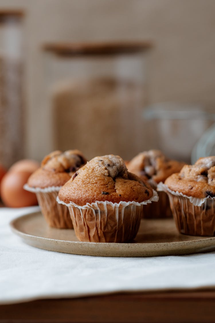 Tasty Muffins With Chocolate Chips On Plate