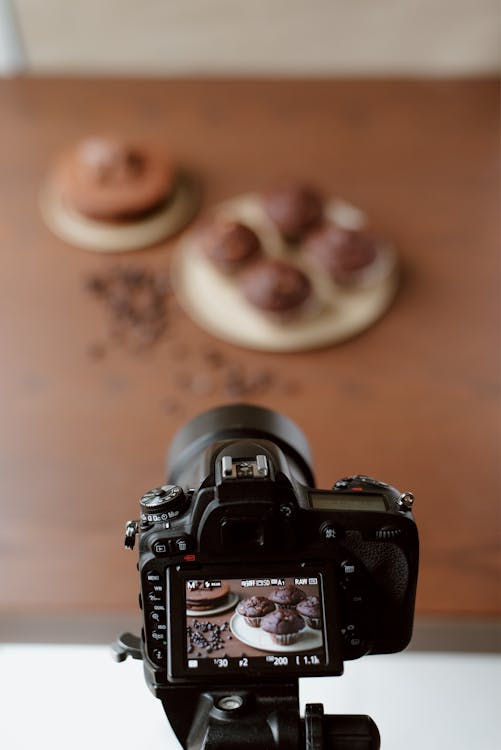 Display of modern photo camera with image of baking products