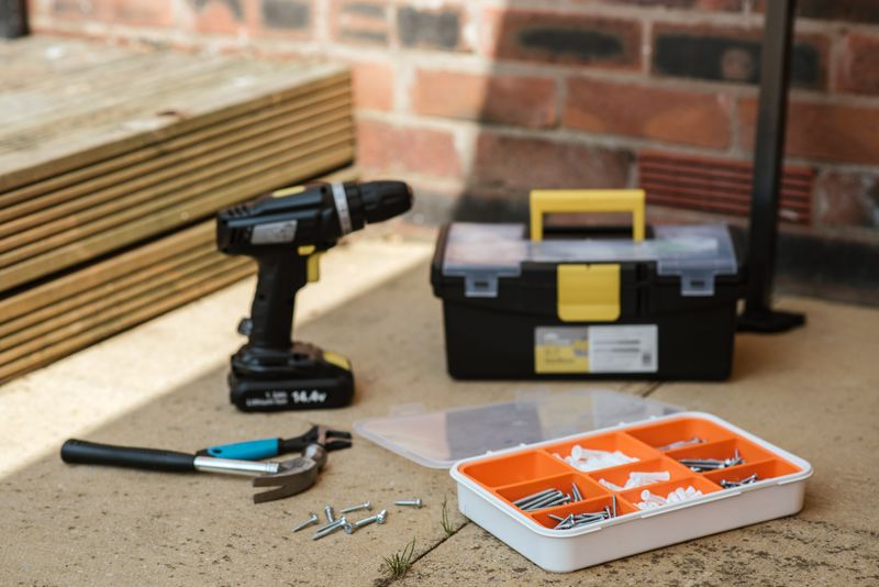 Flooring tools and stacked boards ready for the workshop fit-out