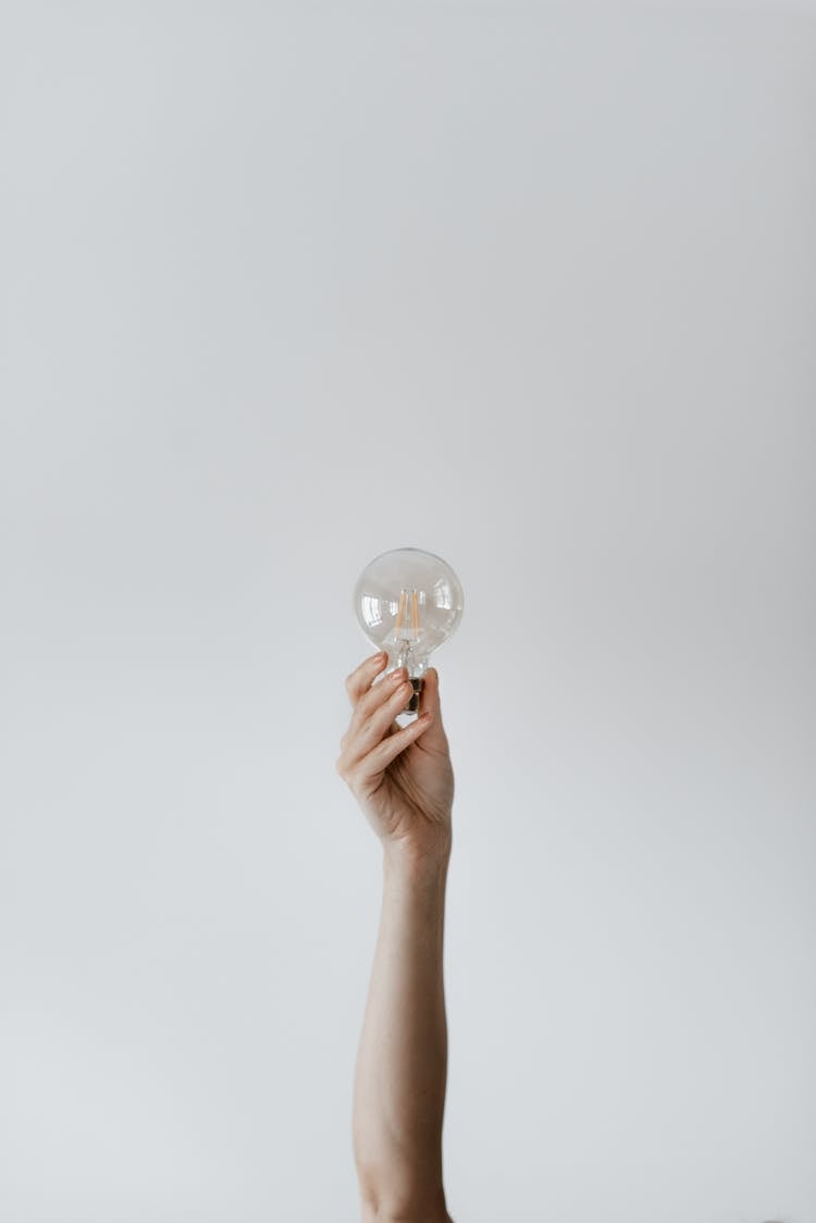 Anonymous Female Showing Light Bulb