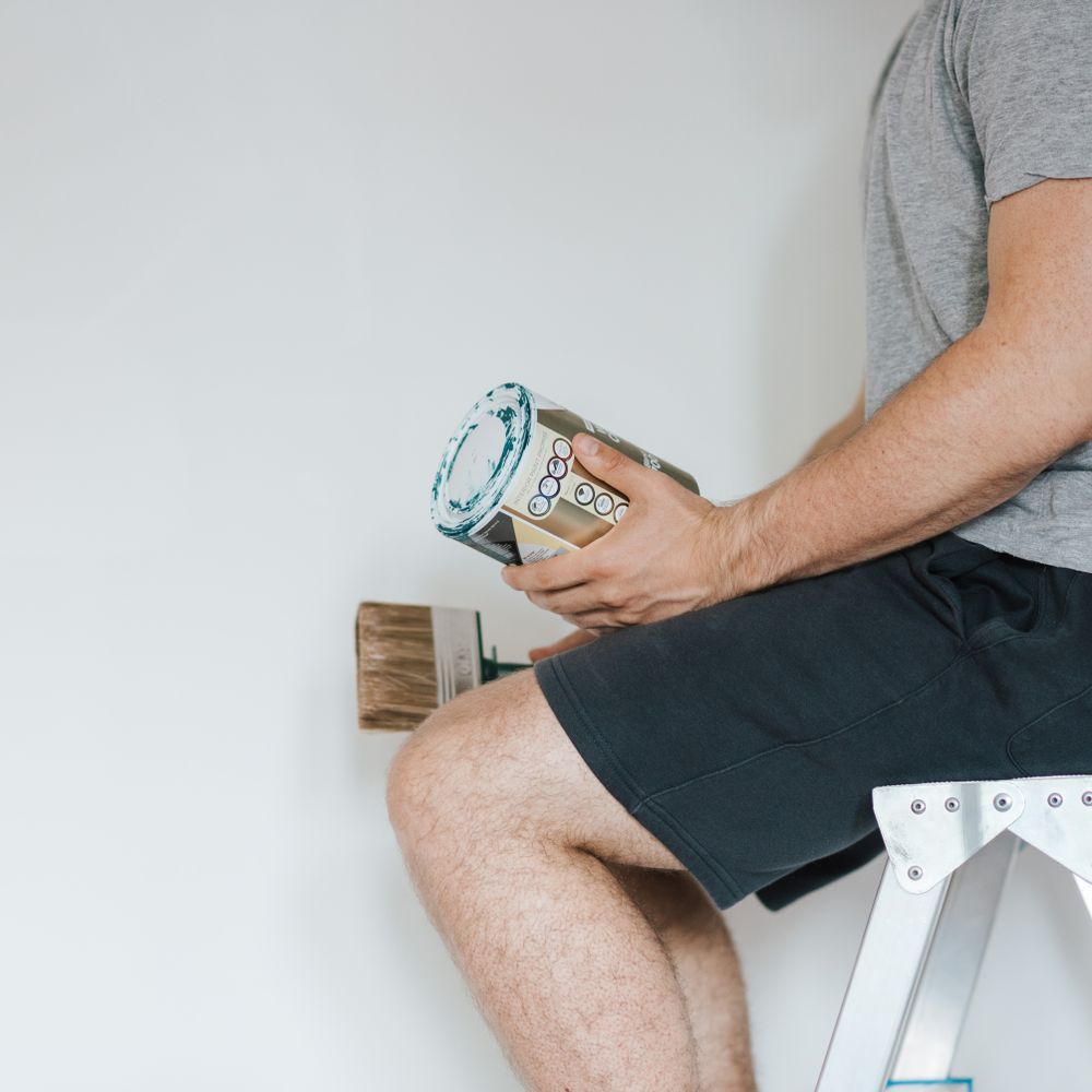 Masonry and Render Painting in Islington — careful masking before painting begins