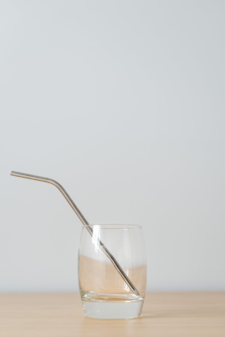 Transparent Glass With Drinking Tube On Table