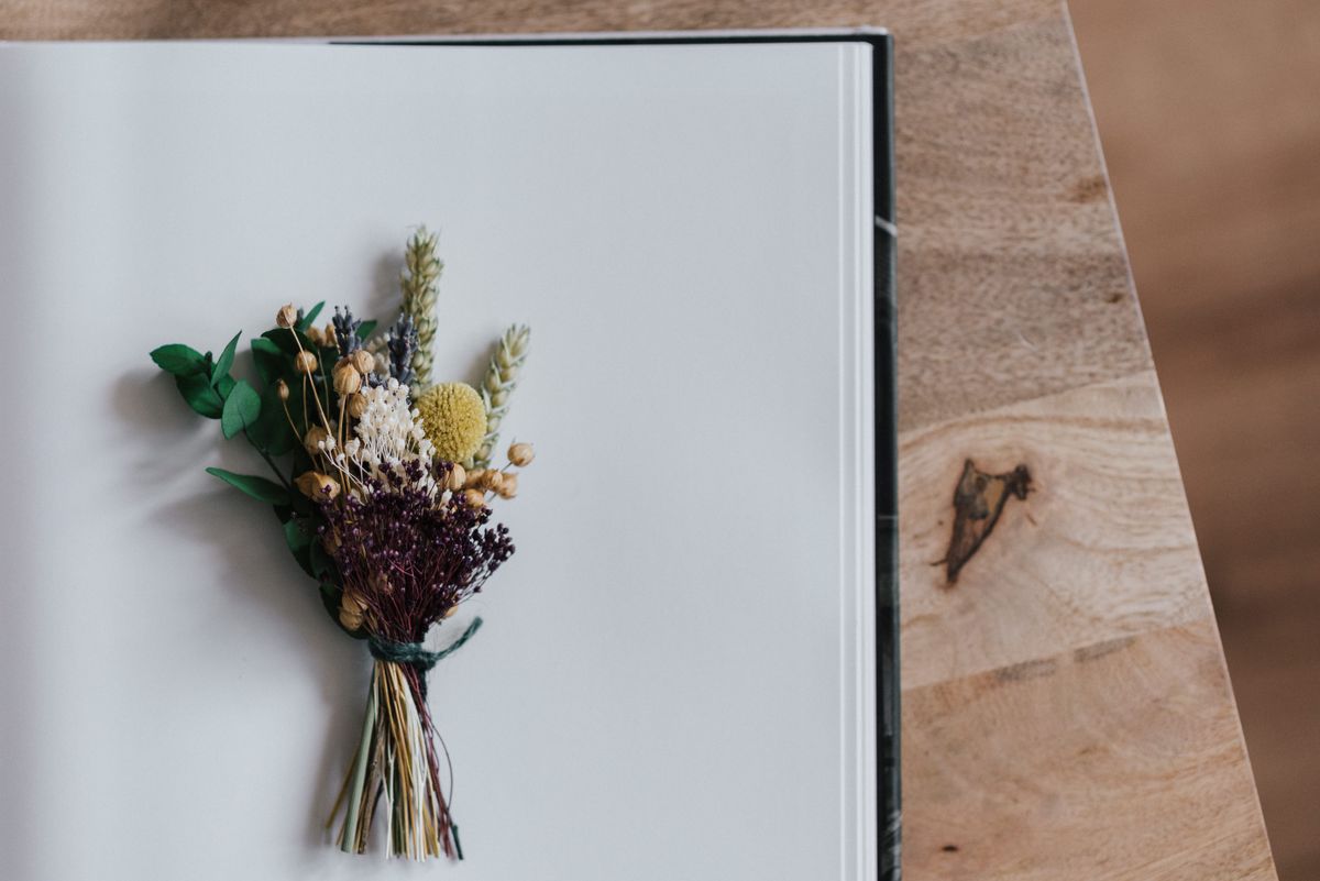 Small dried flower bouquet pressed on a herbarium album sheet