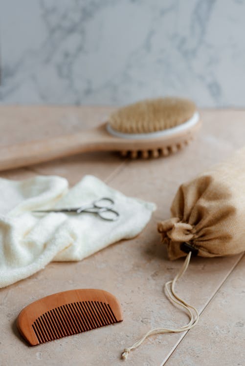 Free Eco friendly bath brush and comb on table Stock Photo