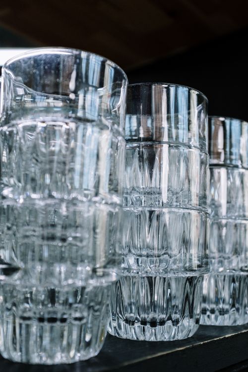 Free Close-up view of stacked clear glasses with reflections, capturing minimalist and geometric design. Stock Photo