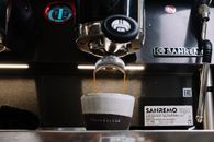 White Disposable Cup on Black and Silver Coffee Maker