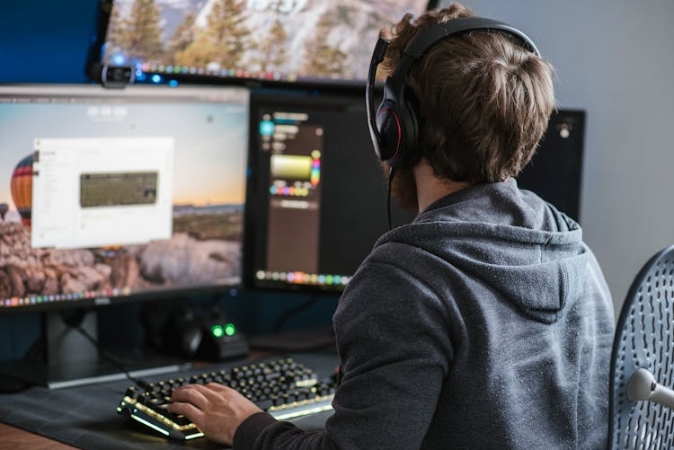 Unrecognizable Man Working On Computer At Home