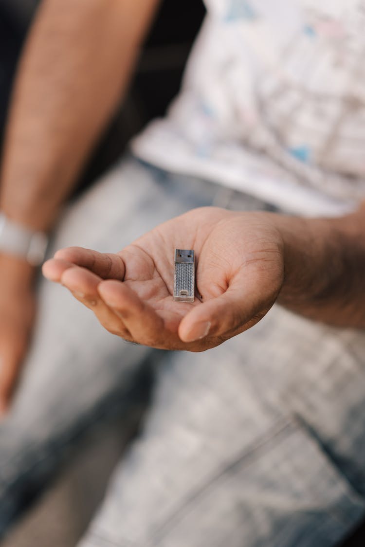 Crop Faceless Man With Memory Card On Hand